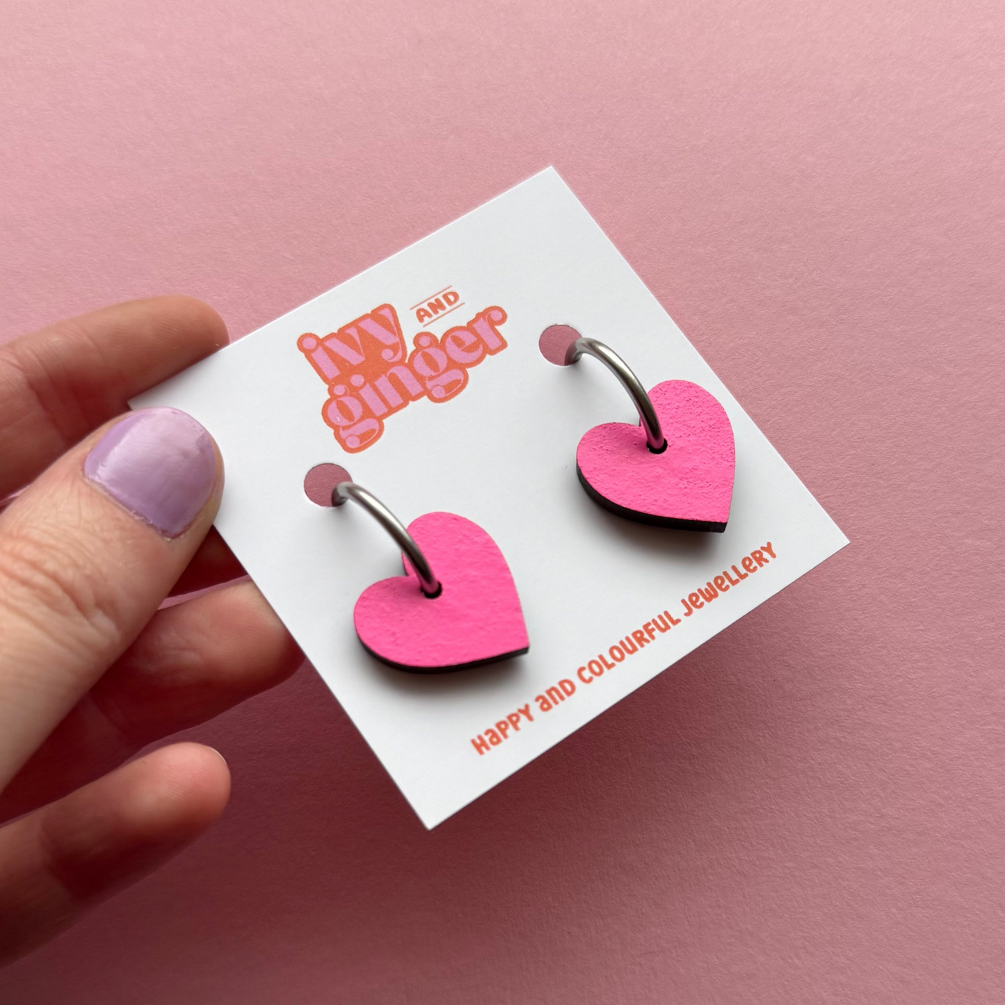 Bright pink heart shaped hoop earrings