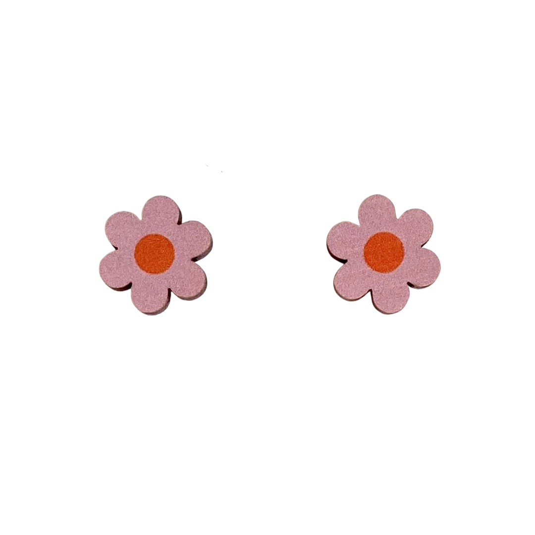 A pair of pink daisy shaped stud earrings with an orange circle in the centre. The earrings are displayed on a white background.