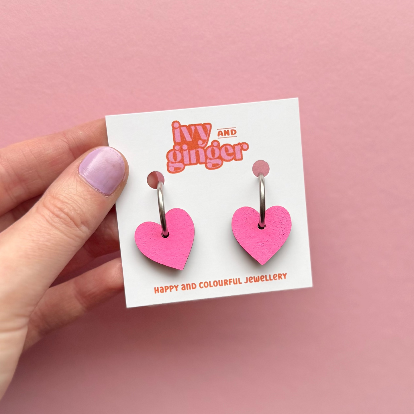 Bright pink heart shaped hoop earrings