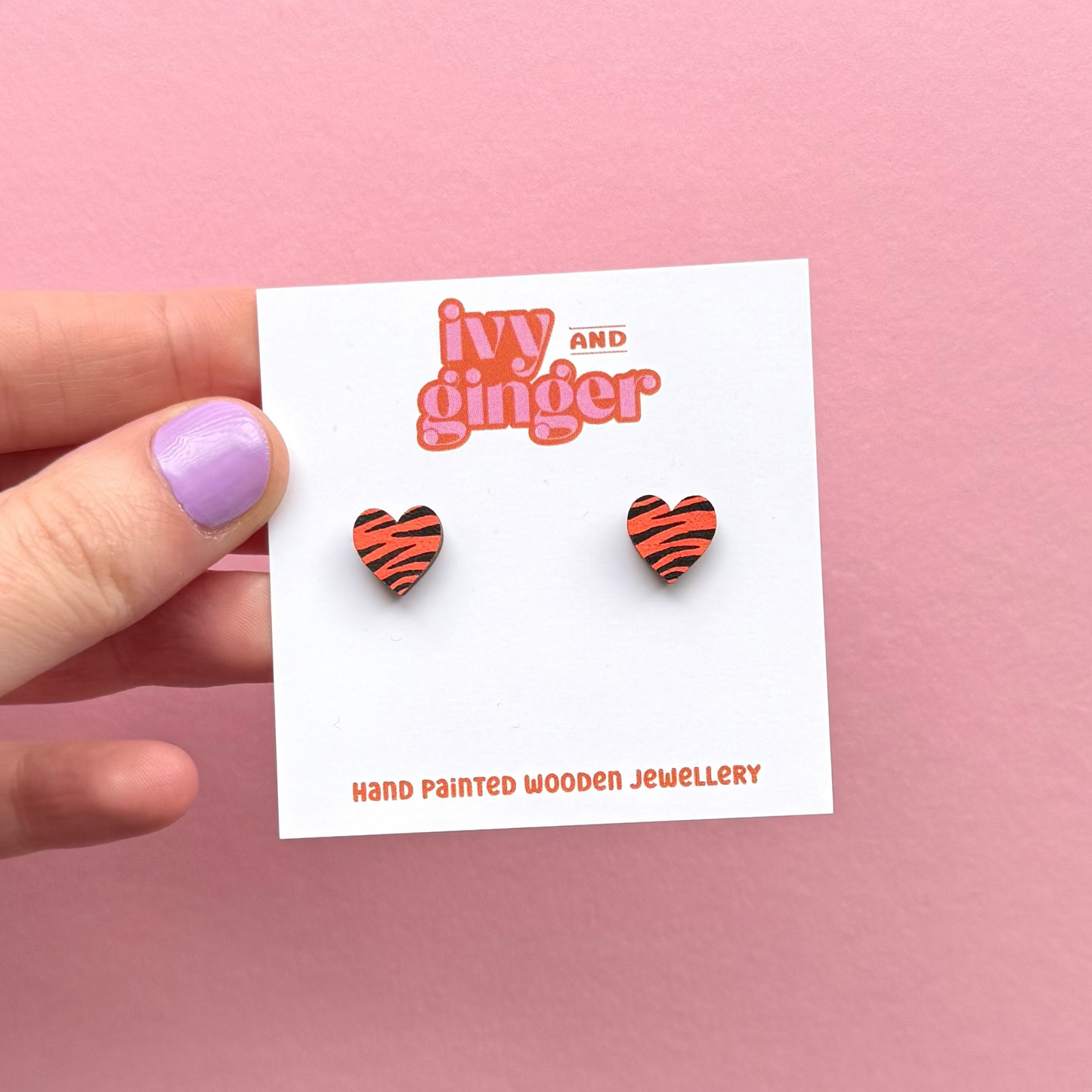 Mini orange and black zebra print heart stud earrings